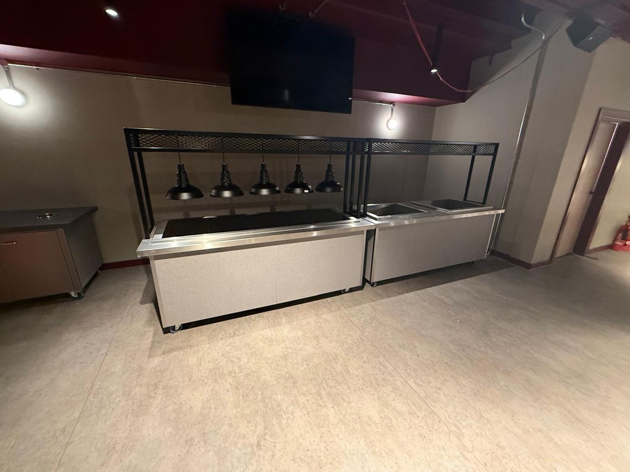 Hospitality lounge servery counter with heat lamps
