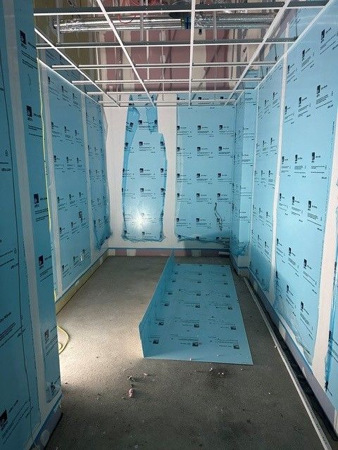 Back-of-house area at the Jubilee Sports Centre during construction, with protected walls