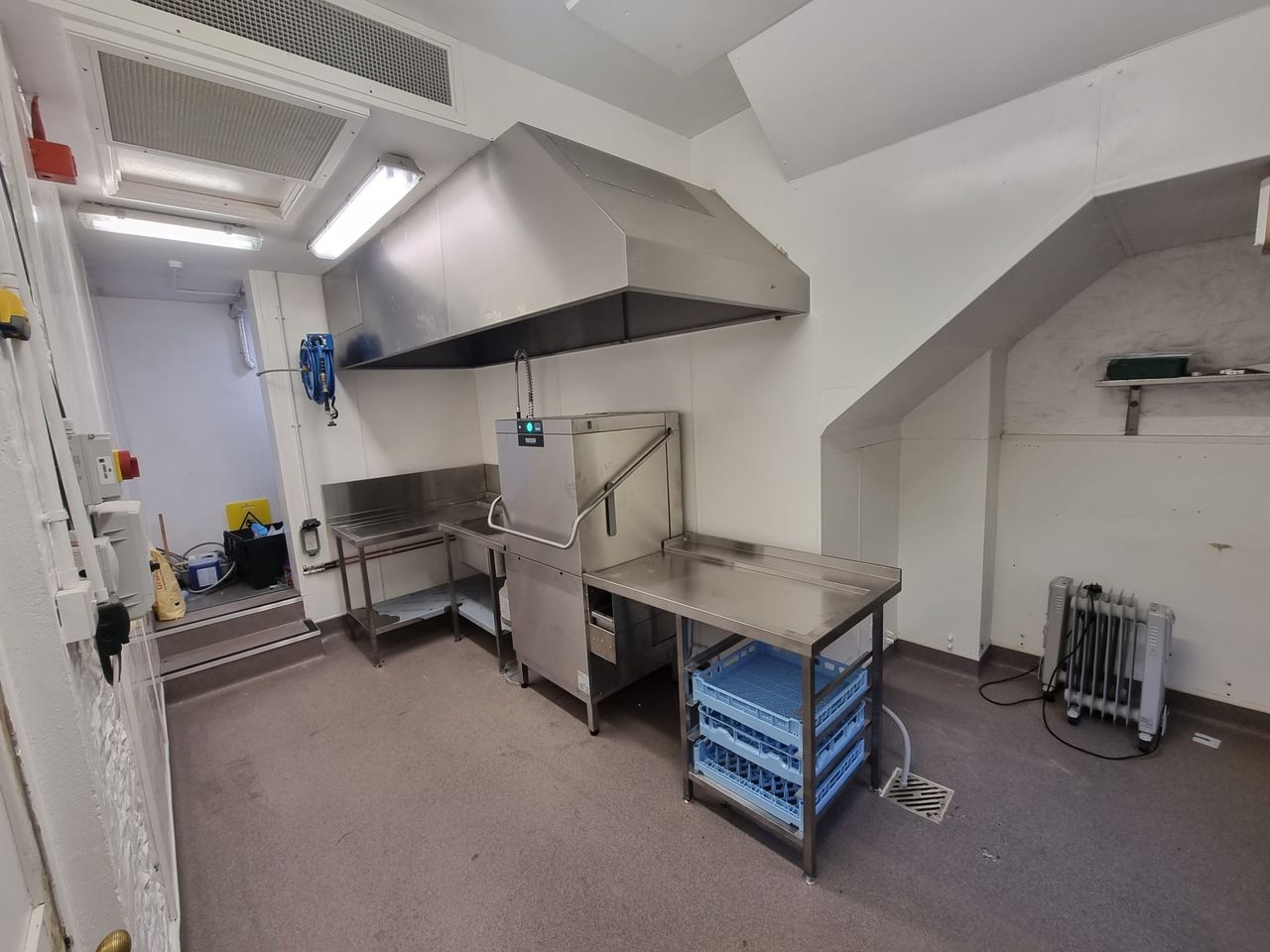 Pass-through dishwasher with stainless steel tabling at West Dean College